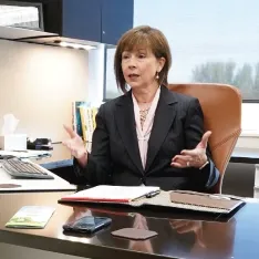 A man and a woman engaged in a professional discussion in an office.